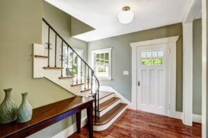 Hallway with ceiling light by the front door & a staircase